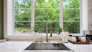 A kitchen with a large window, a stainless steel sink, and a dish rack. - 2 Slides Off Deck, Foosball, Hot Tub, Pets, Let It Slide (Broken Bow)