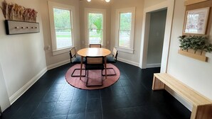 En matplats med ett runt bord, fyra stolar och en takfläkt.