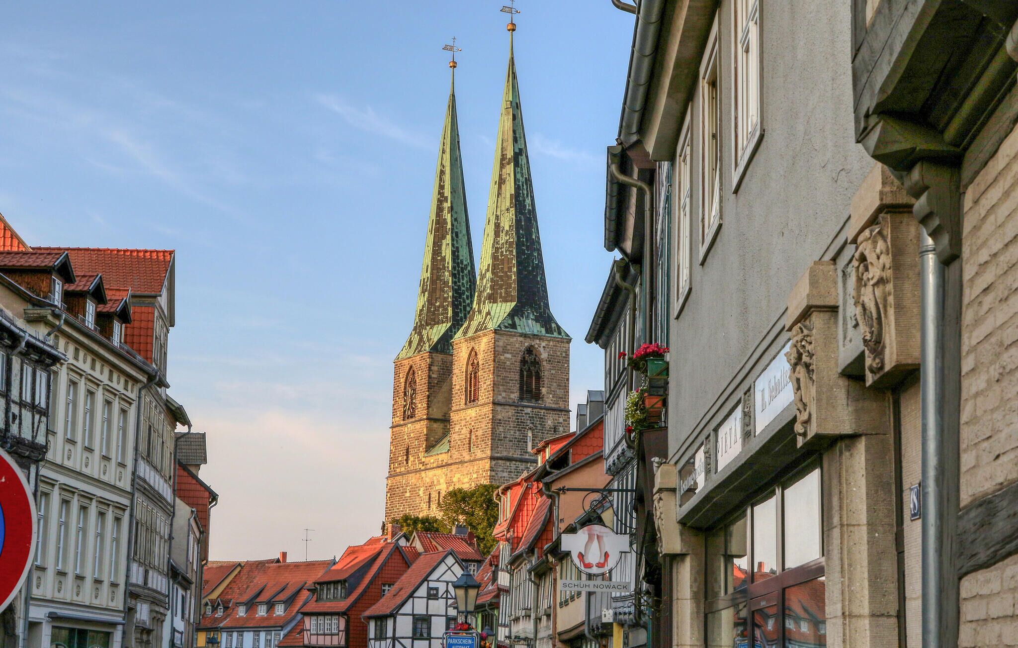 A historic church with three spires, surrounded by traditional European architecture.