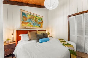 A bedroom with a bed, a nightstand, a lamp, a map on the wall, and a wardrobe. - Hot Tub|Riverfront|15 min to Hot Springs & Skiing (Glenwood Springs)
