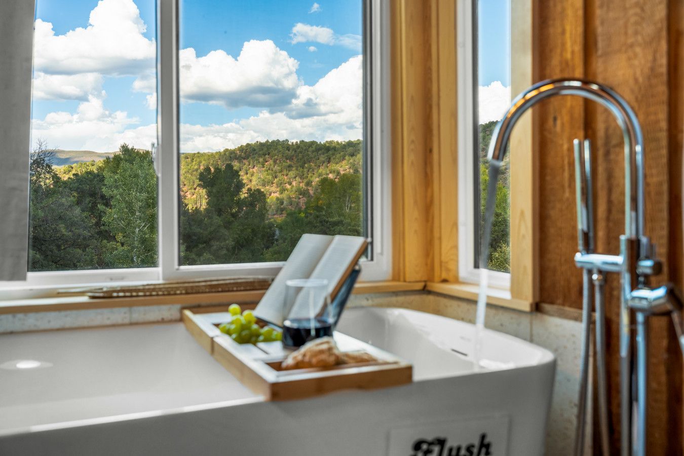 A bathroom with a window, a sink, and a shower.
