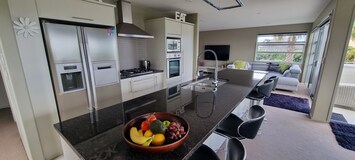 Large granite bench top, gas hob, wall oven, double door fridge with icemaker