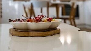 A modern kitchen with white cabinets and a central island. - Second home Next to Sea Garden (Varna)
