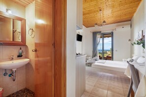 Un bagno con lavandino, specchio e porta in legno.