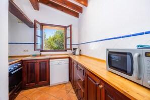 Fridge, microwave, coffee/tea maker, cookware/dishes/utensils