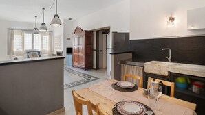 A modern kitchen with a marble countertop, a built-in sink, and pendant lighting. - Studio Apartment 'Da Linda' with Mountain View and Wi-Fi (Cisano sul neva)
