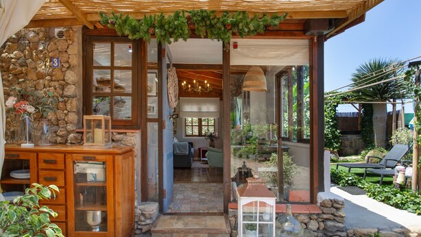 A stone facade, wooden cabinets, a glass display case, a wicker lamp, and a stone lantern.