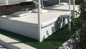 A white outdoor seating area with a white canopy, a small step leading up to it, and a white building in the background. - Holiday Apartment 'Amazing' with Sea View, Shared Pool and Wi-Fi (Mogán)