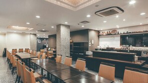 Welcome to our hotel lobby, featuring a reception desk, comfortable seating area, and a large window with an outside view.