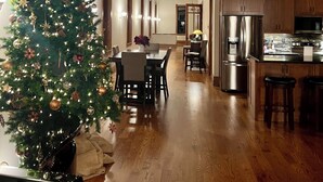 A modern kitchen with wooden cabinets, a stainless steel refrigerator, and a dining area with a wooden table and chairs. - Spacious 2-bedroom loft above the International Owl Center in Houston, MN (Houston)