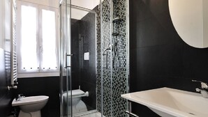 A modern bathroom with a glass-enclosed shower, a white sink, and a toilet. - Dimora San Zanipolo by Wonderful Italy (Venice)