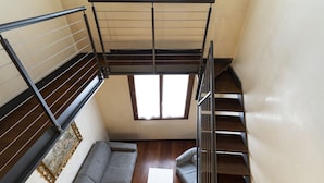 A compact room with a sofa, a small table, and a window. - Doge Palace 5 - Locz (Venice)