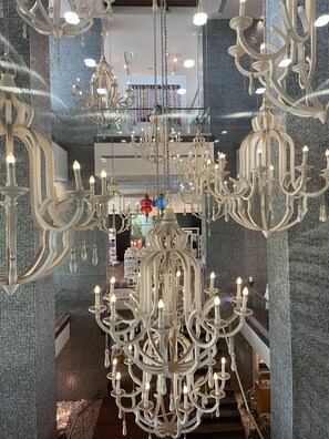 Experience grandeur in this spacious interior with a stunning chandelier and elegant staircase.