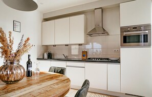 Fridge, stovetop, dishwasher, coffee/tea maker