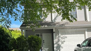 A two-story house with a garage, a driveway, and a well-maintained lawn. -  Charming 3 bedroom home Centrally located in Worcester (Worcester)