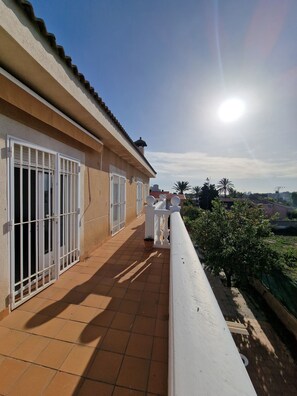 Enjoy the serene views of the surrounding neighborhood from this balcony.