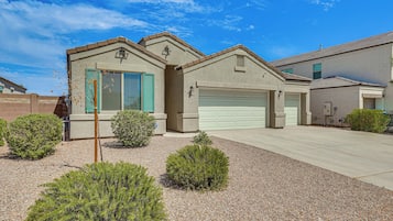 Stylish single-story house with a garage and beautifully landscaped yard.