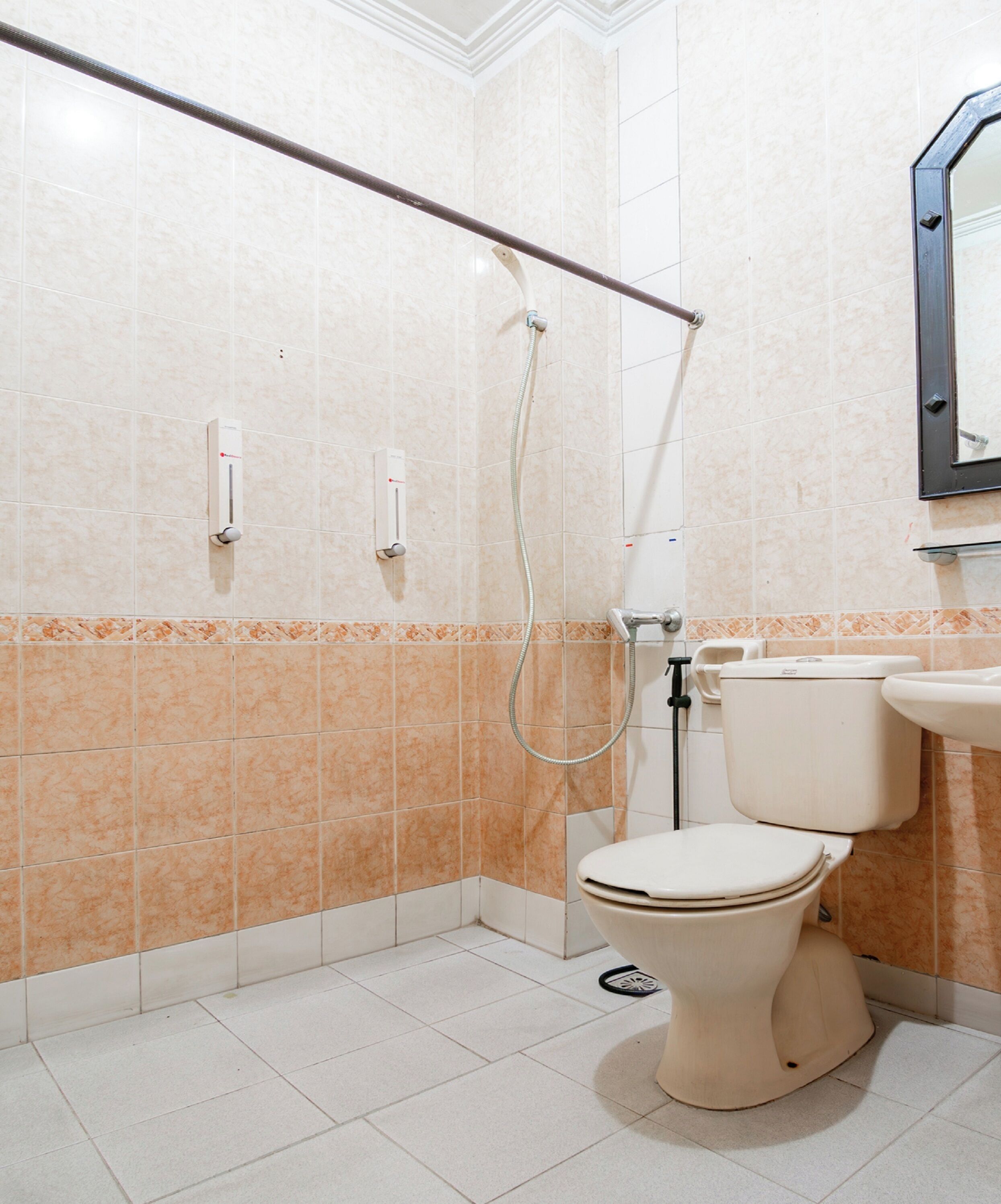A bathroom with a shower, toilet, and sink.