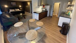 A modern apartment with a living room, dining area, and kitchen. - Close To Whyte University   New Renovation (Edmonton)