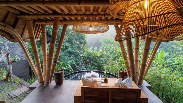 A bamboo structure with a table and chairs, surrounded by lush greenery. - Mahajiva (Abiansemal)