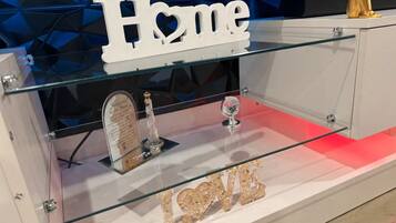 A display case with a 'Home' sign, a crystal trophy, and a 'LOVE' sign.