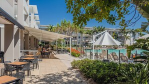 A resort with outdoor seating, a pool, and a covered walkway. - Resort Apartment 4304 at Bells Boulevard (Kingscliff)