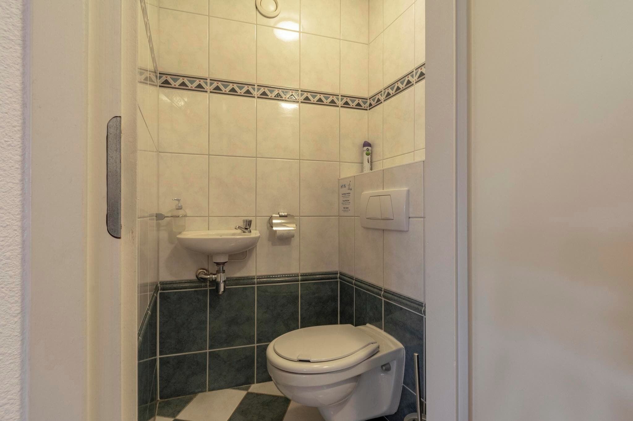 A bathroom with a toilet, sink, and shower.