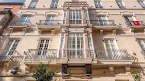 A multi-story building with a central entrance, large windows, and balconies. - Solaga - Casapalma (Málaga)