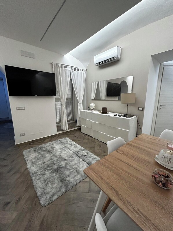 Relax in this stylish room with a flat-screen TV, air conditioning, and a comfortable dining area.