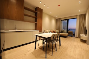 One-Bedroom Apartment with Balcony and Sea View | Living area | 32-inch flat-screen TV with cable channels