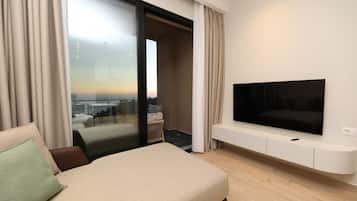 One-Bedroom Apartment with Balcony and Sea View | Living area | 32-inch flat-screen TV with cable channels