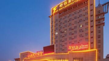 A multi-story hotel with illuminated signage and a prominent entrance.