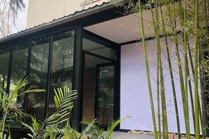 A modern building with large glass windows and a covered entrance. - Wending Yaxuan Hotel (Zhengzhou)