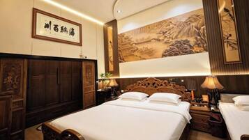 A hotel room with a large bed, wooden headboard, and traditional artwork on the wall.