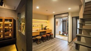 A modern interior with a bar area, wooden flooring, and a staircase. - Kyomachi Hoshizuki (Kyoto)