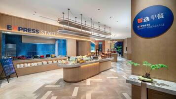 A modern breakfast area with a buffet setup, a sign for Express Start™, and a sign for Express Breakfast.