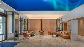 A modern living room with a fireplace, comfortable seating, and large windows. - Holiday Inn Express Datong Pingcheng (Datong)