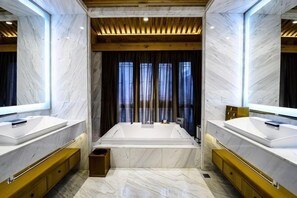 A modern bathroom with two sinks, a large bathtub, wooden ceiling beams, and marble walls. - Ancient City Old Courtyard Boutique Hotel (Beijing)