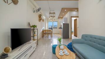 Deluxe Apartment, Sea View | Living area | Smart TV