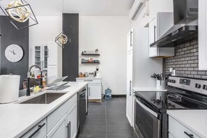 Fridge, microwave, oven, stovetop - Luxe Penthouse Condo | City Views • Parking • Fire (Crawfordsville)