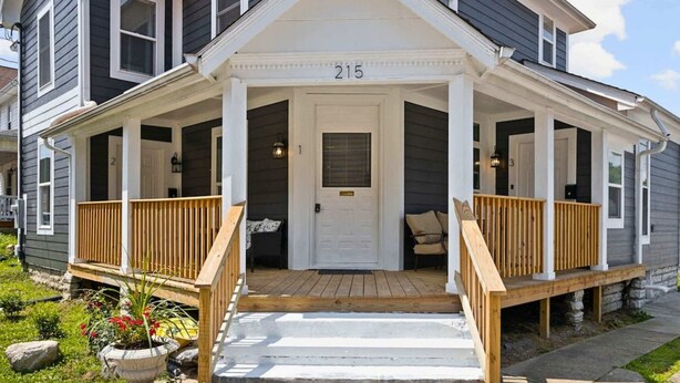 A two-story house with a porch, a front door, and a mailbox. - New Castle Getaway | Fireplace • Prime Location (New Castle)