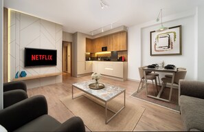 Deluxe Condo, City View | Living area | TV