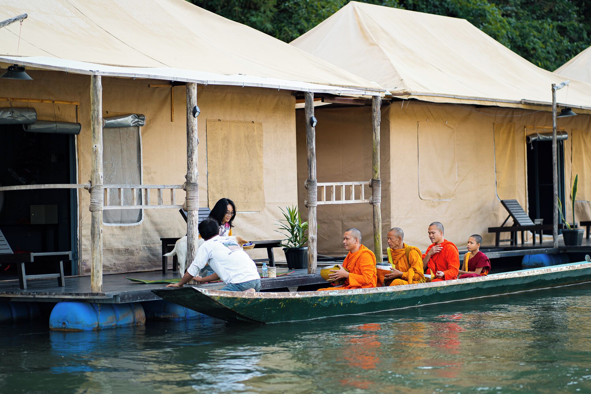 A boat with a covered deck, a table, and chairs.