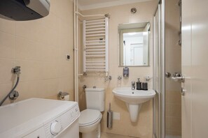 A compact bathroom with a toilet, sink, and shower. - Belgrade Center Apartment Skadarlija III (Belgrade)