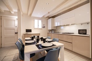 A modern kitchen with a dining area set for six.