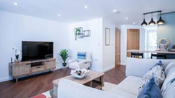 Apartment (1 Bedroom) | Living area | 32-inch Smart TV with cable channels