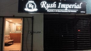 A hotel entrance with a reception desk and a sign that reads "Rush Imperial." - Hotel Rush Imperial (Indore)