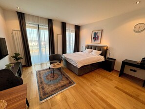 Apartamento superluxo, vista para o rio | Área de estar | TV de tela plana 50 polegadas com canais a cabo, TV, Netflix