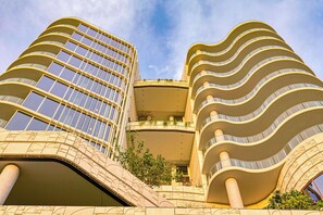 A modern building with curved balconies and a glass facade. - Forbes Manaa Living 2BR+2Bath Suite (Applecross)