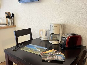 Enjoy meals in the room's dining area, equipped with a coffee maker and toaster.